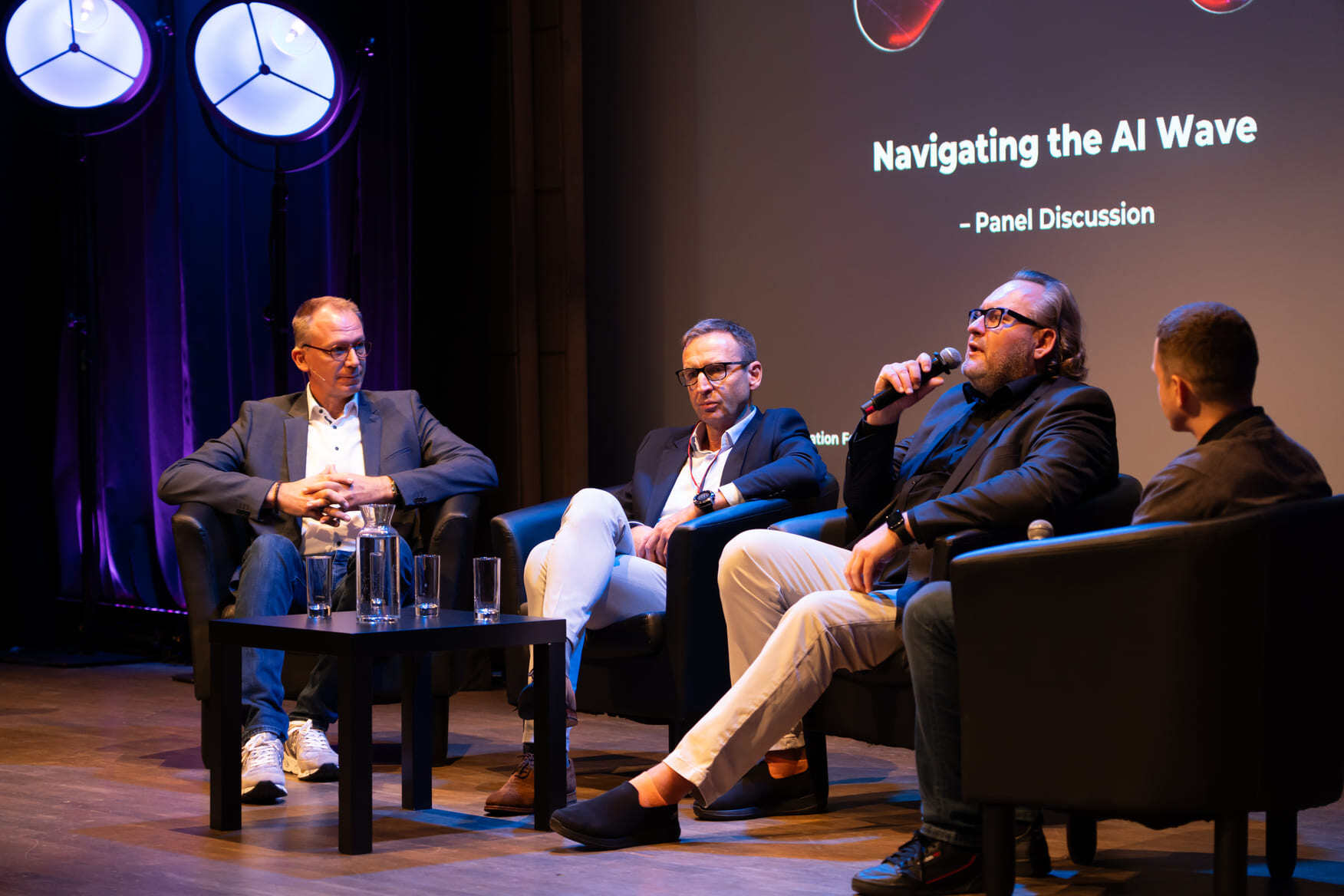 Damian_Ragan__Bartłomiej_Nocoń__Andreas_Becks_and_Michał_Walerowski_speaking_on__Navigating_the_AI_Wave___Panel_Discussion_